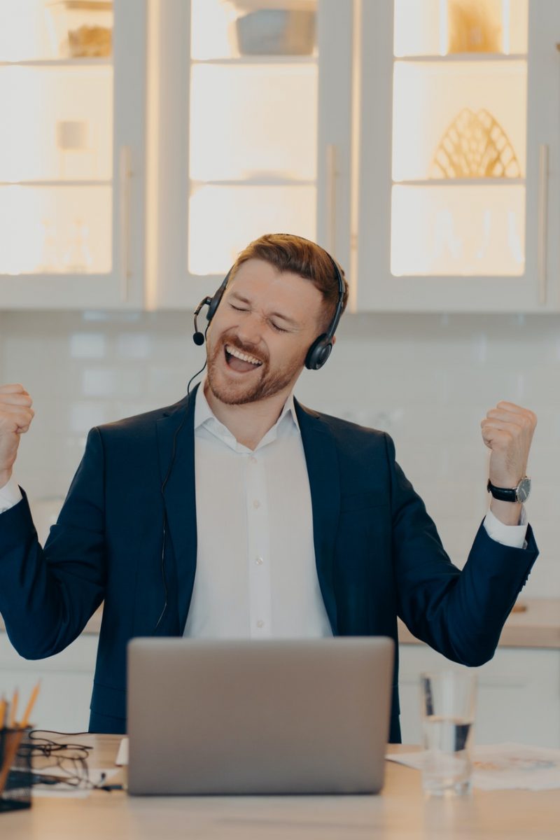 Happy manager in suit enjoying his work at home